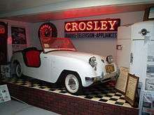 White car and refrigerator on display