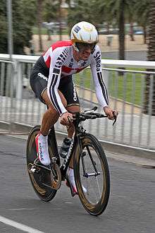 A cyclist wearing a skinsuit and riding an aerodynamic bike