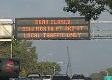 overhead road closed sign over freeway