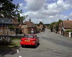 View of a village street lined with red brick buildings