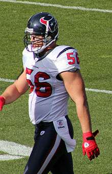  A picture of an American football player walking on a playing field