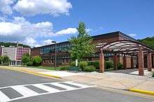 Two-story brick building façade, entranceway, and round theater