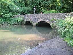 Stone two arch bridge over water