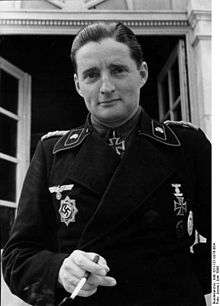 A man wearing a military uniform with an Iron Cross displayed at the front of his uniform collar.