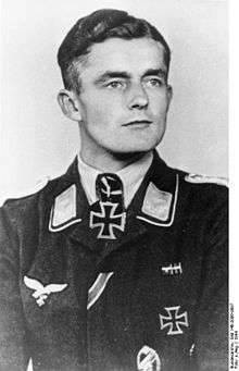 A man wearing a military uniform with an Iron Cross displayed at the front of his uniform collar.