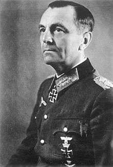 Black-and-white portrait of a man in semi profile wearing a military uniform with an Iron Cross displayed at his neck.