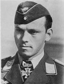 A portray of a man wearing a military uniform, side cap and neck order in shape of an Iron Cross.