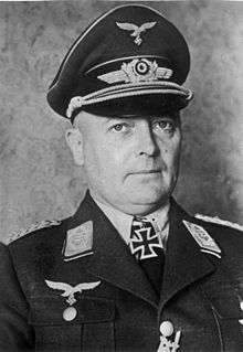 A man wearing a military uniform with an Iron Cross displayed at the front of his uniform collar.