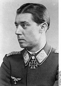 A man wearing a military uniform with an Iron Cross displayed at the front of his uniform collar.