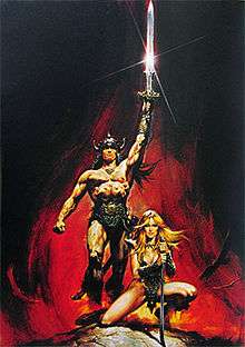 A man, wearing nothing but a loincloth and a horned helm, strides forth, holding a sword aloft in his left hand. A blond woman kneels in front of him, holding a curved blade with both hands.