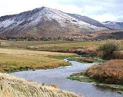 A small river meandering through grassland