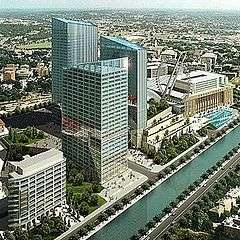 View of a project that consists of three buildings, a Ferris wheel and a mall