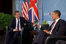US President Barack Obama and British Prime Minister David Cameron trade bottles of beer to settle a bet they made on the U.S. vs. England World Cup Soccer game (which ended in a tie), during a bilateral meeting at the G20 Summit in Toronto, Canada, Saturday, June 26, 2010