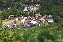 A small town constructed in a medieval style, surrounded by forest