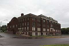 Large brick building on a shallow slope