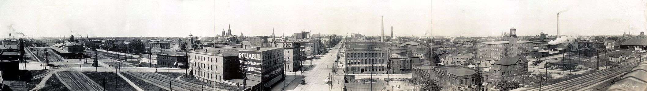 Elevated view of a cityscape with a set of railroad tracks crossed by several roads