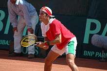 Fred Gil prepares himself to return a serve.