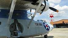 The PBY Catalina with the main building and North Hangar in the background.