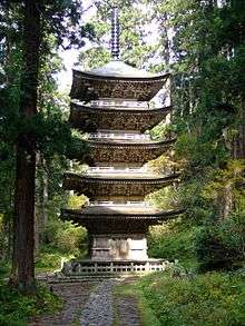 A five-storied wooden pagoda in a forest.