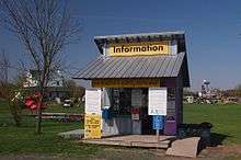 Booth with signs saying "information" and "your donation is greatly appreciated