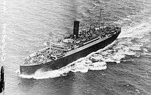 Black and white photo of a large boat with a single funnel at sea