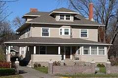 Two-story house with extensive porch, dormers, brick chimneys