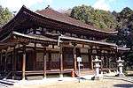 Wooden building with slightly raised floor, an open veranda and a pyramid shaped roof.