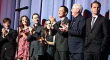 A photograph of the cast of the 2010 film Inception, including Ellen Page in the middle.