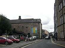 The side of a building with a small lantern on the roof