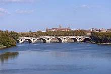 Arched bridge crossing a broad river