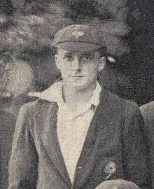 A man in a cricket cap and blazer