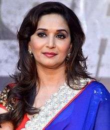 Madhuri Dixit is seen looking away from the camera.