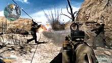 Three men wielding guns walk up a dirt ridge towards an explosion of dust.