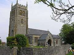 Stone building with prominent square tower.