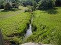 A small brook flowing slowly through school grounds