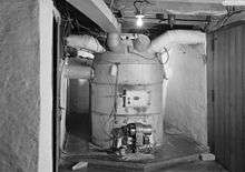 A photo of an "octopus"-type hot-air furnace in a basement.