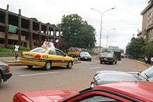 Picture of Okpara Avenue with a Coal City Cab driving past.