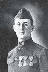 Head and shoulders of a man in a neatly pressed military uniform with three medals on his chest, a tight upright collar, and garrison cap.