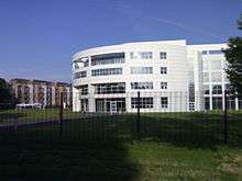 Large, white, four-storey building with a curved facade