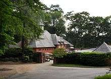 A two-story brick building and complex housing golf carts