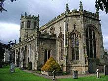 A elaborately decorated church with embattled parapets and crocketed pinnacles.