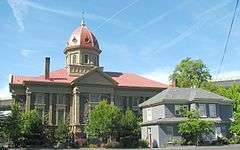 Photograph of a domed church with a smaller two-story house adjacent