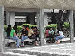 Filipino domestic workers chatting outdoors on their day off