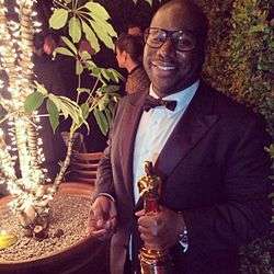 Steve McQueen holding the trophy for Best Picture Oscar for the film at the 86th Academy Awards