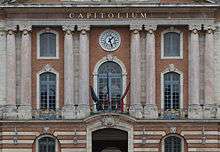 Three flags tied up in front of the Capitole