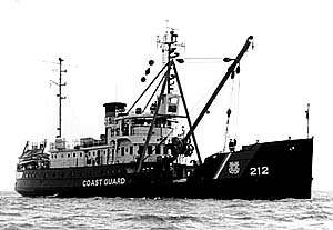 Historic photograph of the USCGC Fir, a heavy-duty vessel with a large crane boom rising from its fore section.