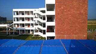 Another red-brick building with white balconies