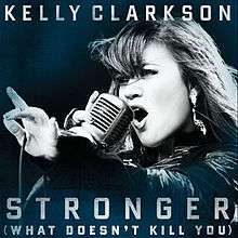 A blue-tint-in-a-black-and-white image of a woman singing. Her right hand is holding a vintage carbon microphone in front of her mouth. The microphone's wire is resting on her left hand between her thumb and her index finger. Below her, the words "Stronger" and "(What Doesn't Kill You)" are written in white upper-case letters.