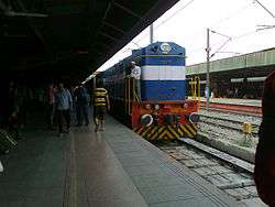 A refurbished locomotive waiting at a junction