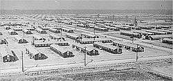 fifty plain long wooden buildings interlaced with roads